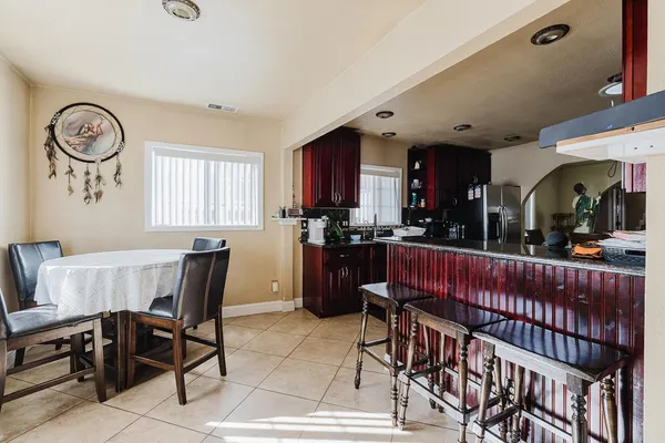 a kitchen with stainless steel appliances granite countertop a stove a sink dishwasher and cabinets with wooden floor