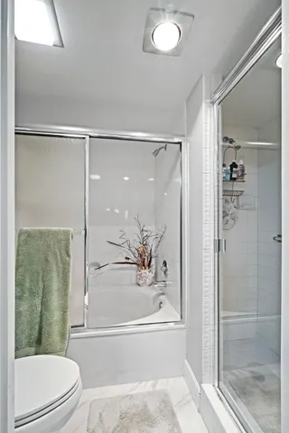 a bathroom with a toilet and a shower