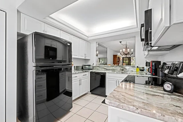 a kitchen with a sink stainless steel appliances and cabinets