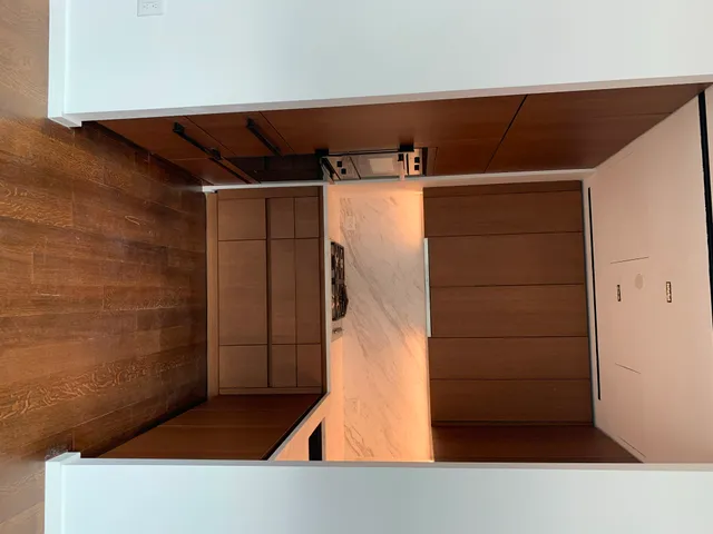 a view of a room with wooden floor and sink