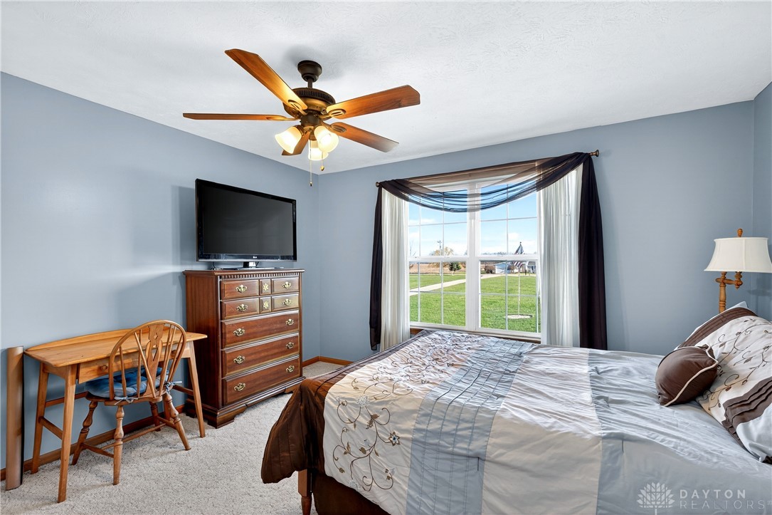 6560 Snyder Road Fletcher, OH 45326 - Photo 34 of 71 This peaceful bedroom offers comfort with a view of the expansive green yard.