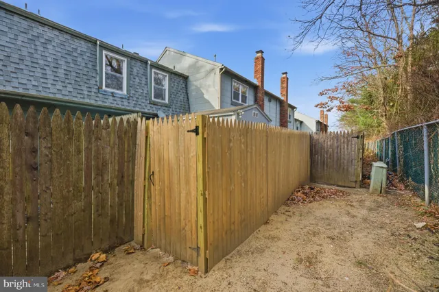 a view of a house with a cars park side of a road