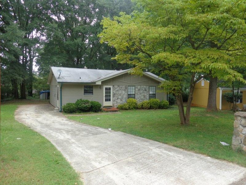 1650 Freedom Valley, Unit 23 Decatur, GA 30032 - Photo 1 of 1 a front view of a house with a yard and trees