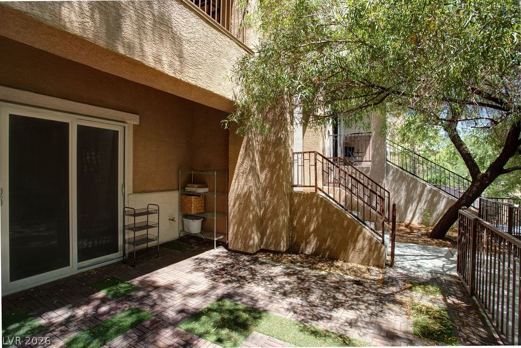 7724 Vibrant Thread Court Las Vegas, NV 89149 - Photo 39 of 43 A private patio space with brick pavers and artificial turf offers a tranquil outdoor retreat.