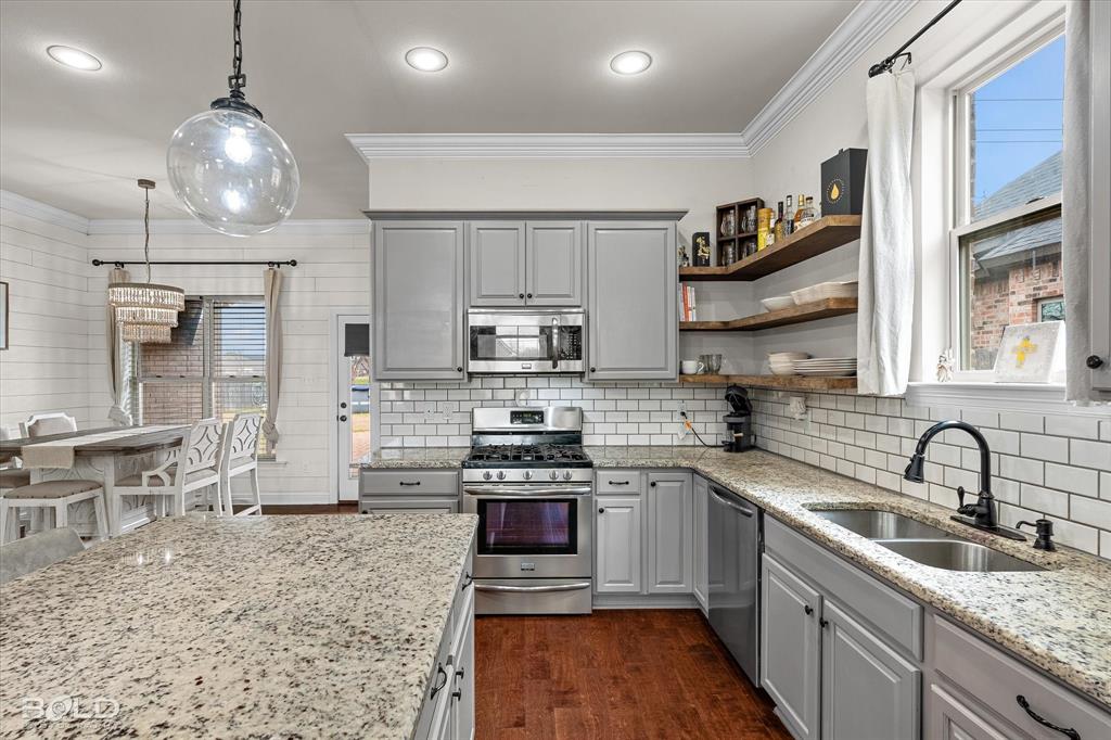 946 Maize Street Bossier City, LA 71111 - Photo 24 of 39 a kitchen with stainless steel appliances granite countertop a sink stove and refrigerator