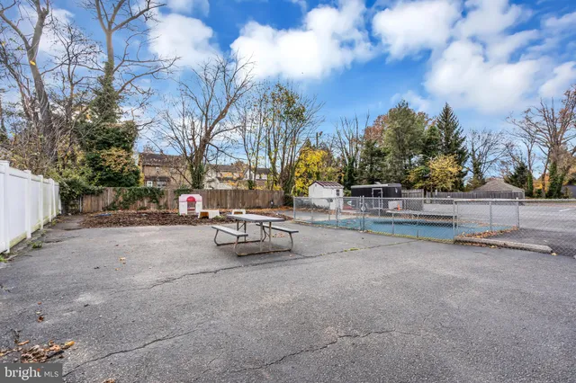 a view of street with bench and trees