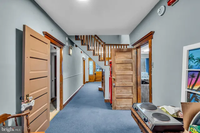 a view of a livingroom with furniture and staircase