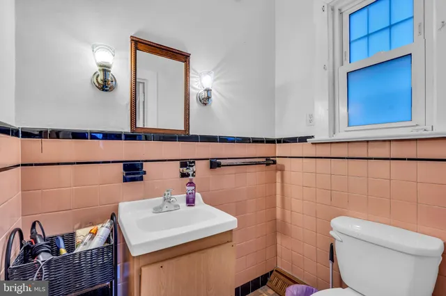 a bathroom with a sink a toilet and mirror