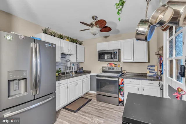 a kitchen with stainless steel appliances granite countertop a sink and cabinets