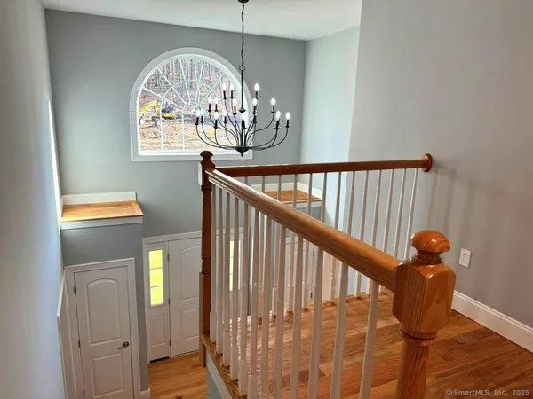 a view of entryway and hall with wooden floor