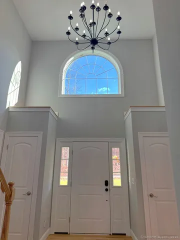 wooden floor with a chandelier