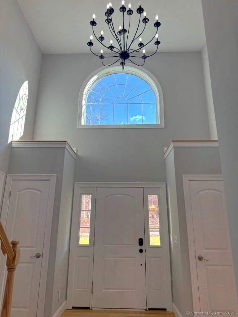 9 Pembroke Hill Road Wolcott, CT 06716 - Photo 8 of 18 wooden floor with a chandelier