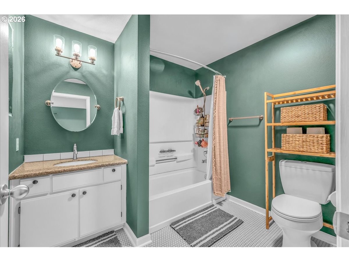 5142 Southwest Multnomah Boulevard, Unit H Portland, OR 97219 - Photo 17 of 26 a bathroom with a sink a toilet and shower