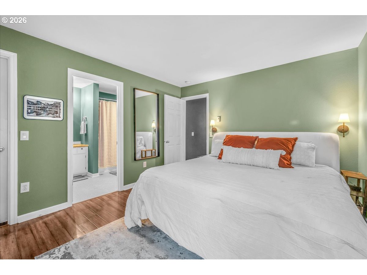 5142 Southwest Multnomah Boulevard, Unit H Portland, OR 97219 - Photo 20 of 26 a bedroom with a bed and window