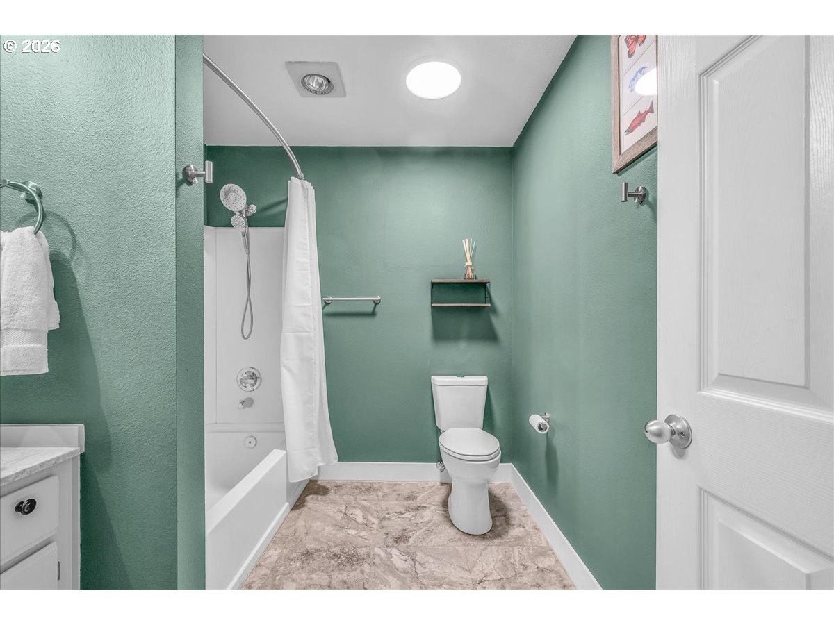 5142 Southwest Multnomah Boulevard, Unit H Portland, OR 97219 - Photo 22 of 26 a bathroom with a toilet and a sink