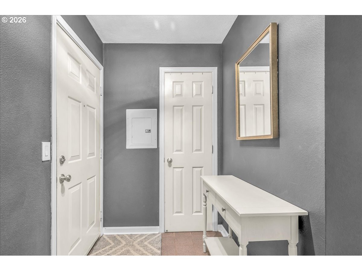 5142 Southwest Multnomah Boulevard, Unit H Portland, OR 97219 - Photo 5 of 26 a bathroom with a sink a mirror and a toilet