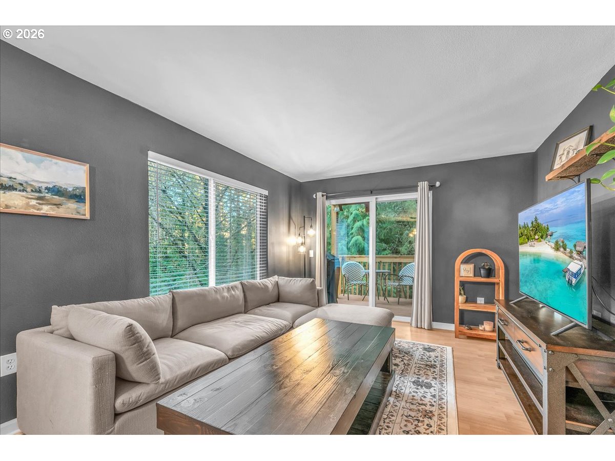 5142 Southwest Multnomah Boulevard, Unit H Portland, OR 97219 - Photo 8 of 26 a living room with furniture and a flat screen tv