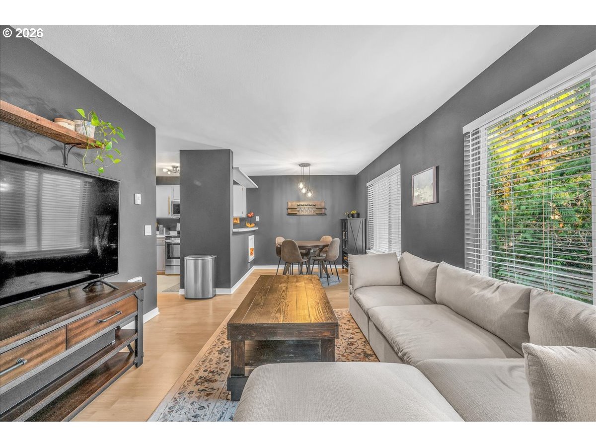 5142 Southwest Multnomah Boulevard, Unit H Portland, OR 97219 - Photo 9 of 26 a living room with furniture and a flat screen tv