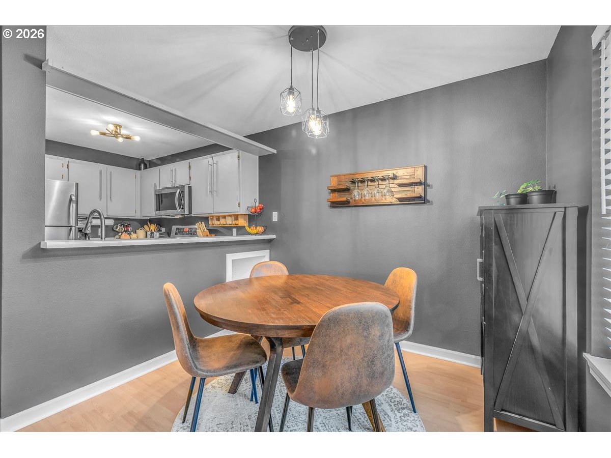 5142 Southwest Multnomah Boulevard, Unit H Portland, OR 97219 - Photo 10 of 26 a dining room with furniture and window