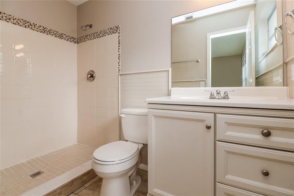 4173 Raccoon Loop New Port Richey, FL 34653 - Photo 11 of 16 a bathroom with a sink a toilet and shower