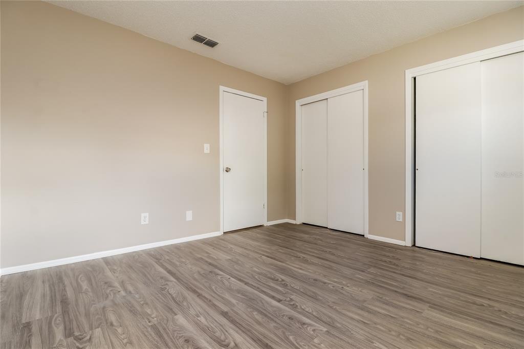 4173 Raccoon Loop New Port Richey, FL 34653 - Photo 13 of 16 a view of an empty room with wooden floor