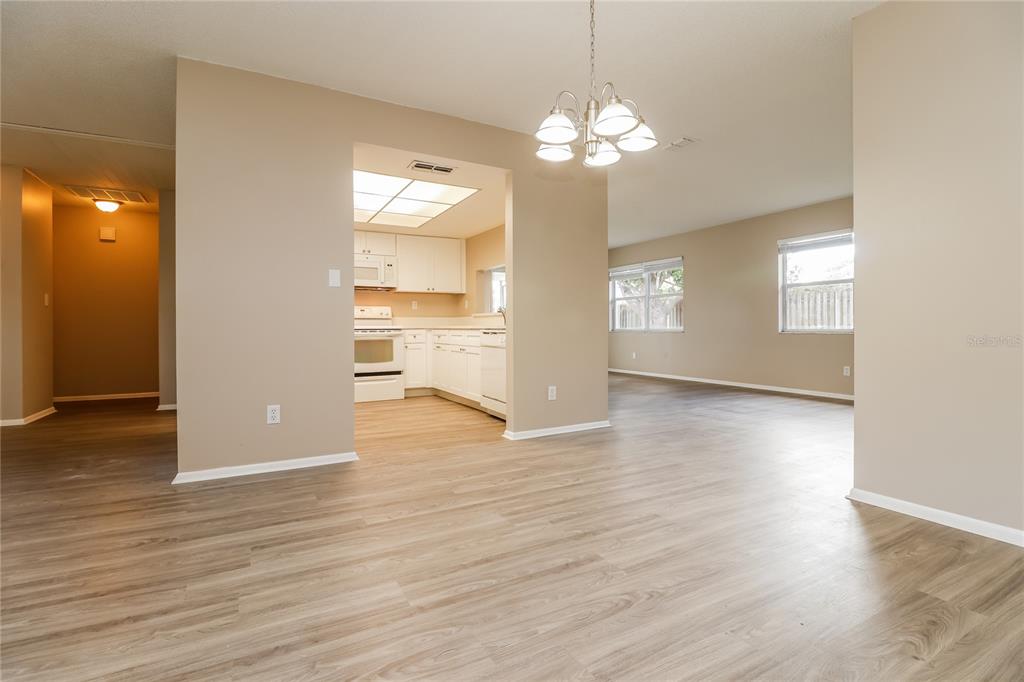 4173 Raccoon Loop New Port Richey, FL 34653 - Photo 3 of 16 wooden floor in an empty room with a window