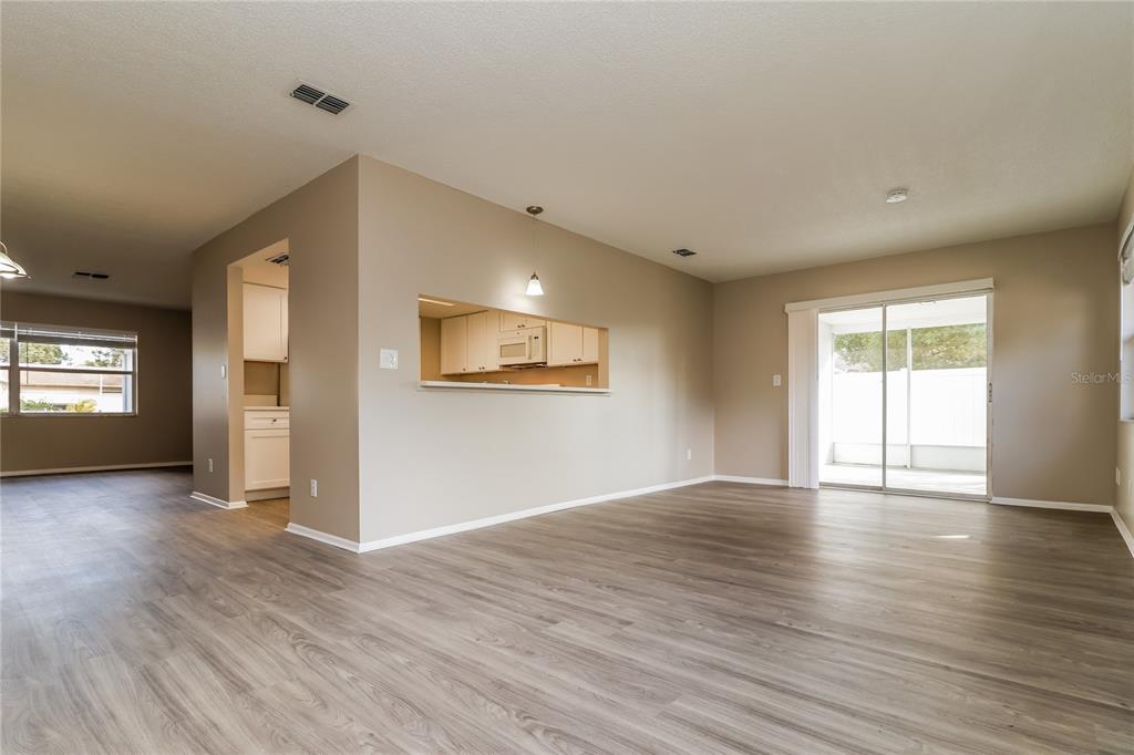 4173 Raccoon Loop New Port Richey, FL 34653 - Photo 8 of 16 wooden floor in an empty room with a window
