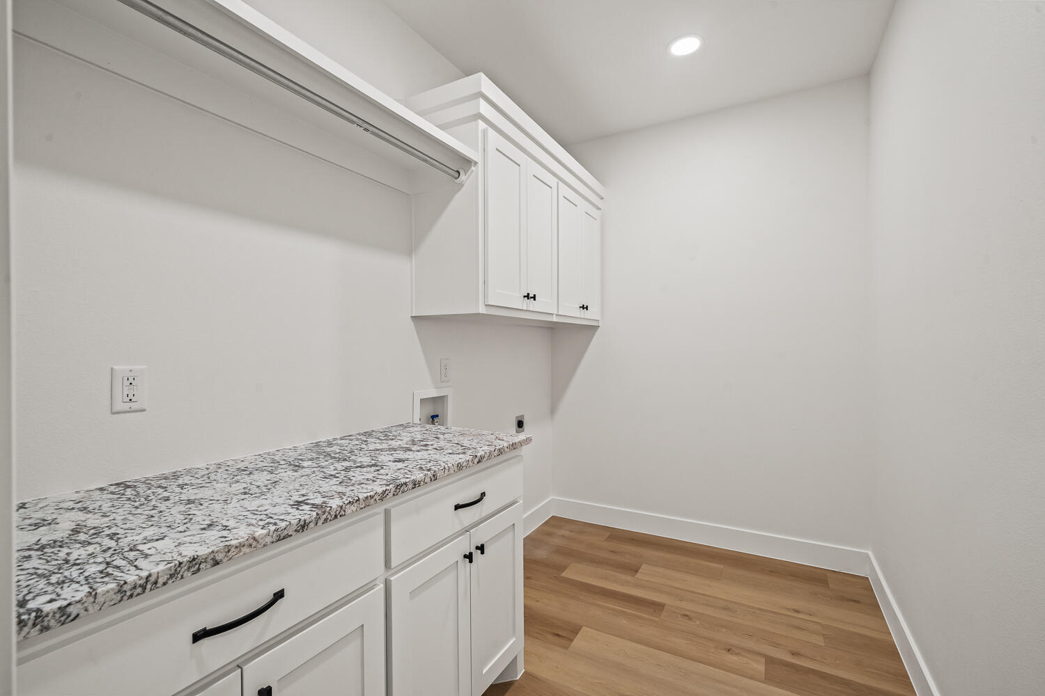 4062 Hawk Road Ropesville, TX 79358 - Photo 18 of 45 a kitchen with granite countertop white cabinets and a wooden floor