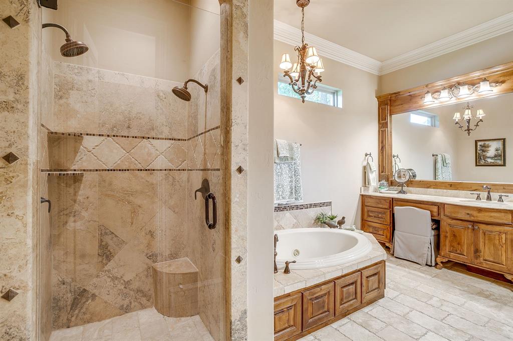 6251 Paper Shell Way Fort Worth, TX 76179 - Photo 18 of 40 a spacious bathroom with a granite countertop tub sink a mirror a shower and vanity