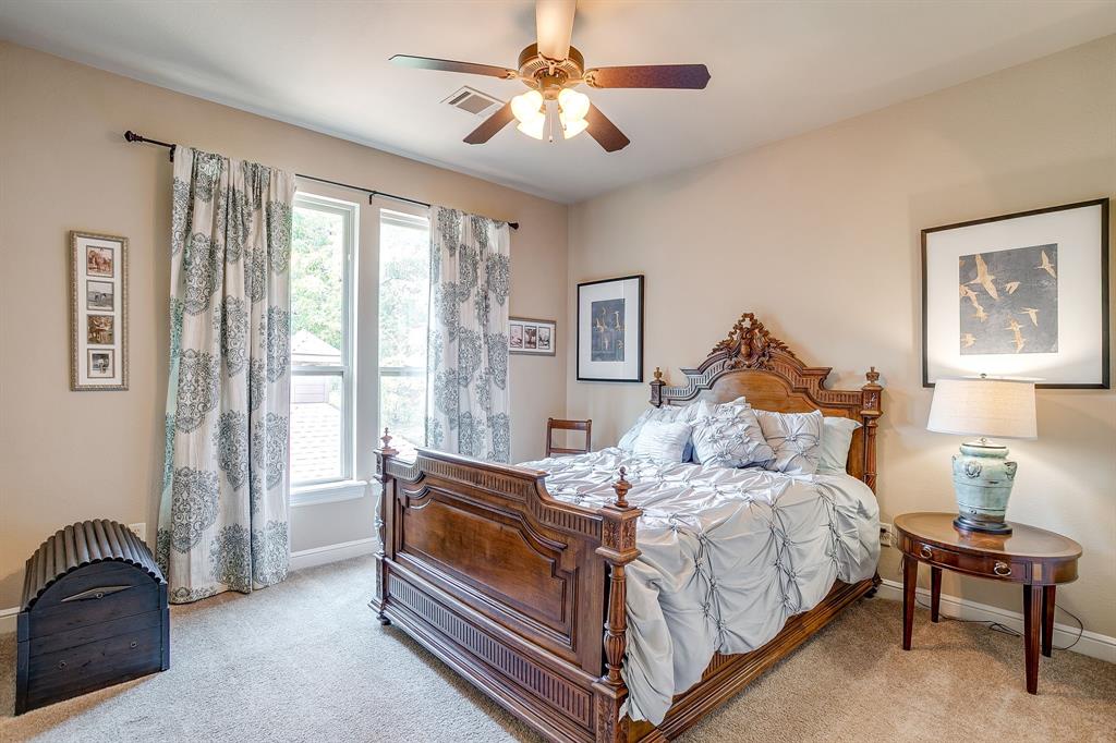 6251 Paper Shell Way Fort Worth, TX 76179 - Photo 21 of 40 a bedroom with a bed and a chandelier