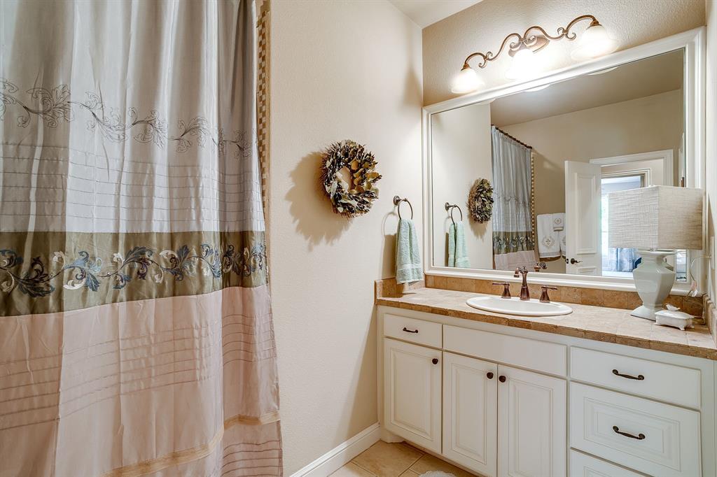 6251 Paper Shell Way Fort Worth, TX 76179 - Photo 22 of 40 a bathroom with a double vanity sink and a mirror