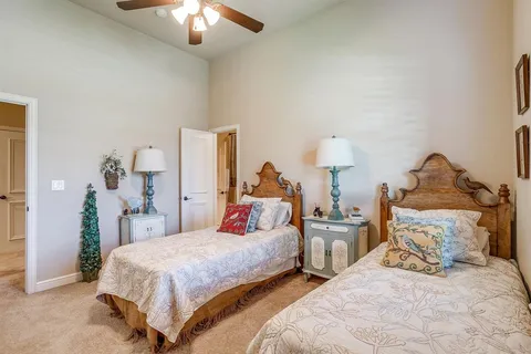 a bedroom with two beds and a chandelier