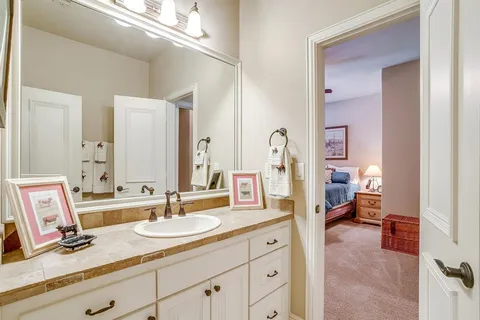 a en suite bathroom with double sink and a mirror