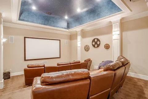 a projector room with a couch and a flat screen tv