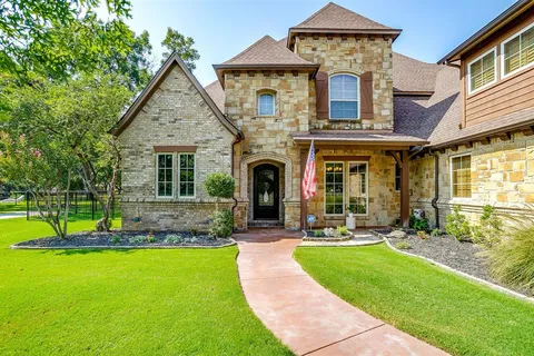a front view of a house with a yard table and chairs
