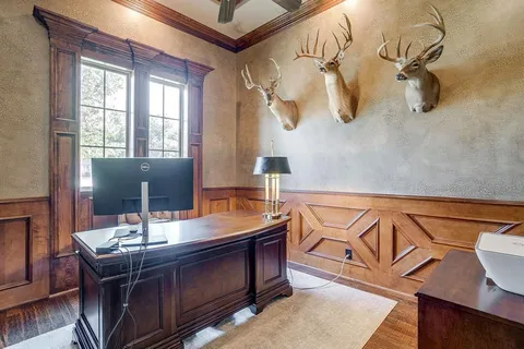 a room with table chairs and wooden floor