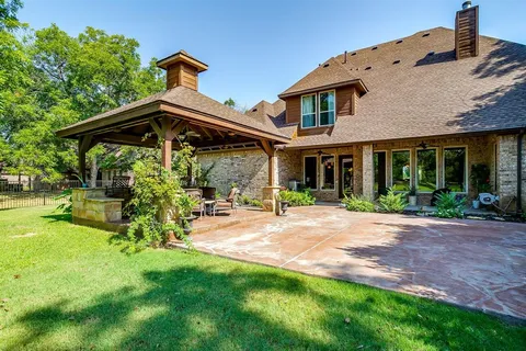 a front view of a house with a yard table and chairs