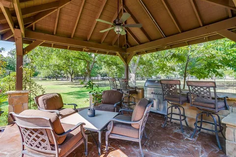 a view of a patio with a table chairs and a backyard