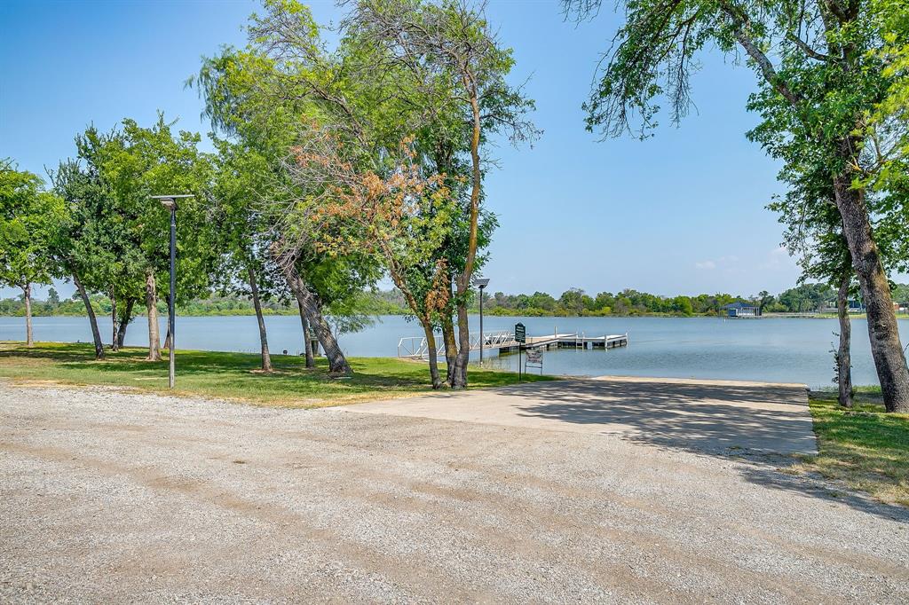 6251 Paper Shell Way Fort Worth, TX 76179 - Photo 38 of 40 a view of a lake with a yard and large trees
