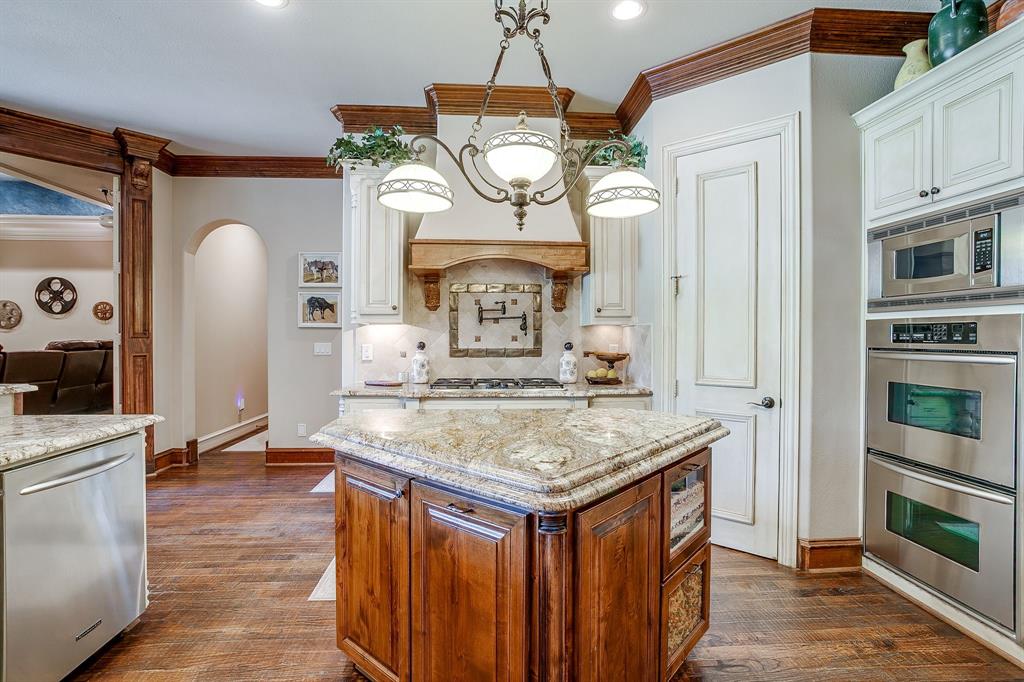 6251 Paper Shell Way Fort Worth, TX 76179 - Photo 9 of 40 a view of kitchen island with wooden floor