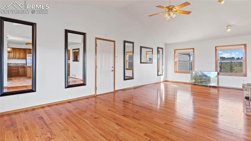 16250 Herring Road Colorado Springs, CO 80908 - Photo 11 of 50 a view of an empty room with wooden floor and a window