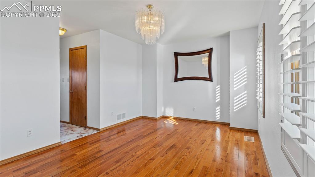 16250 Herring Road Colorado Springs, CO 80908 - Photo 14 of 50 a view of empty room with wooden floor