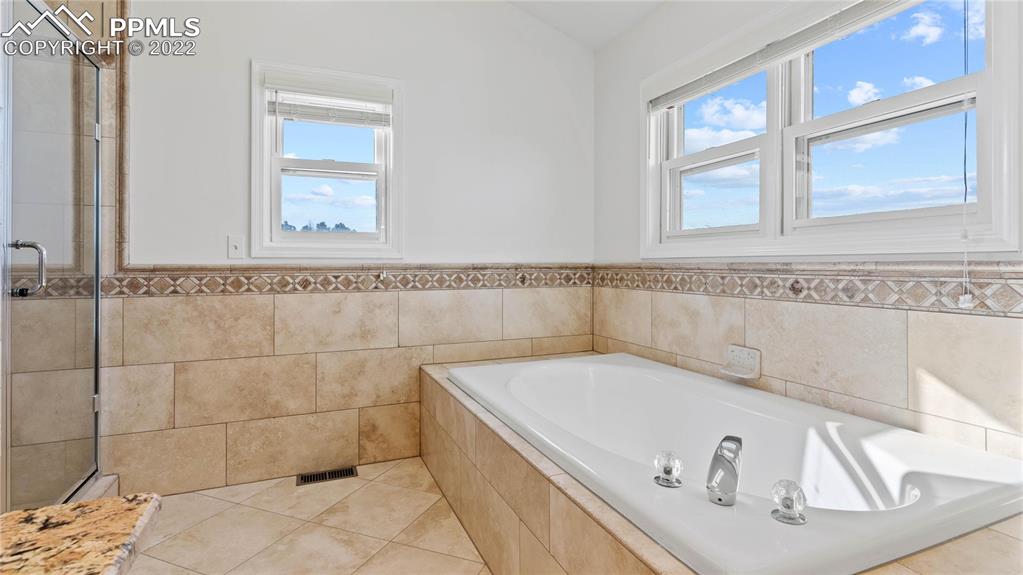 16250 Herring Road Colorado Springs, CO 80908 - Photo 20 of 50 a bath tub sitting in a bathroom next to a window