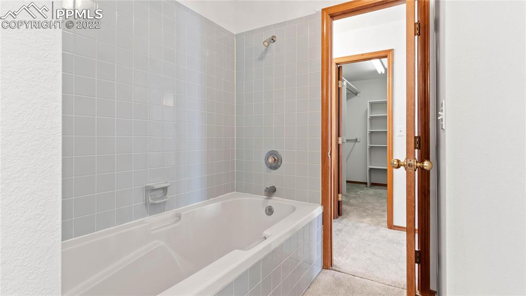 16250 Herring Road Colorado Springs, CO 80908 - Photo 30 of 50 a bathroom with a bathtub and a shower