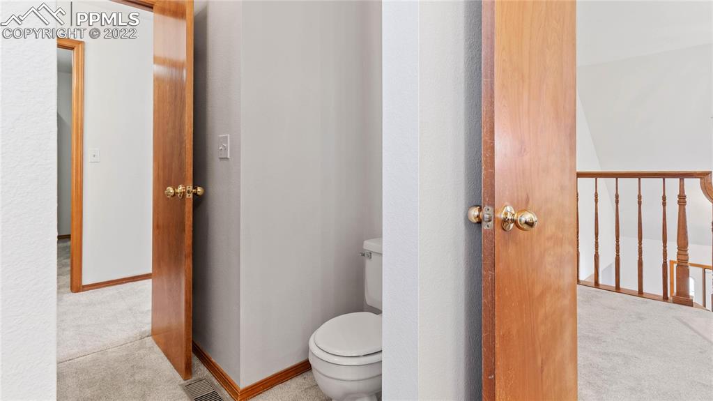 16250 Herring Road Colorado Springs, CO 80908 - Photo 31 of 50 a bathroom with a granite countertop toilet and a sink