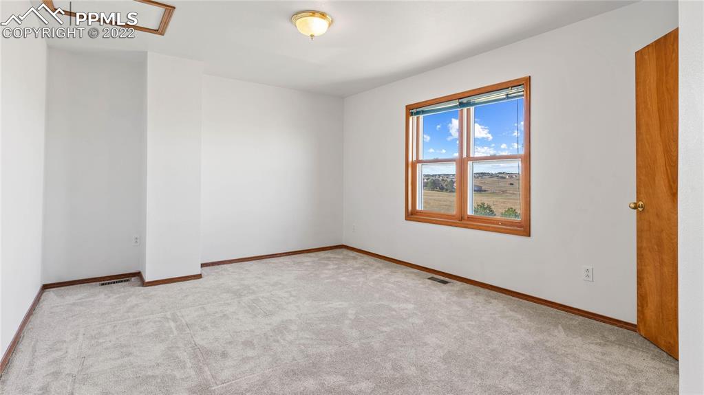 16250 Herring Road Colorado Springs, CO 80908 - Photo 33 of 50 an empty room with windows