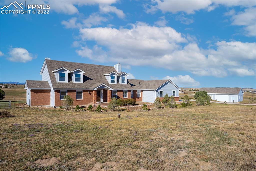 16250 Herring Road Colorado Springs, CO 80908 - Photo 41 of 50 a view of a big house with a big yard and large trees