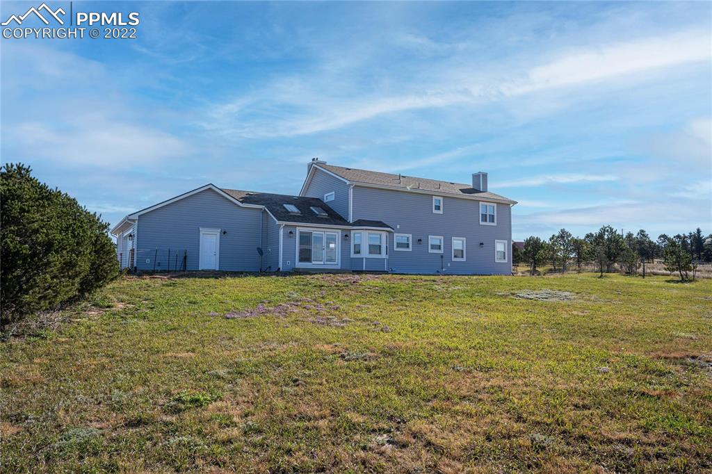 16250 Herring Road Colorado Springs, CO 80908 - Photo 42 of 50 a view of a large house with a big yard
