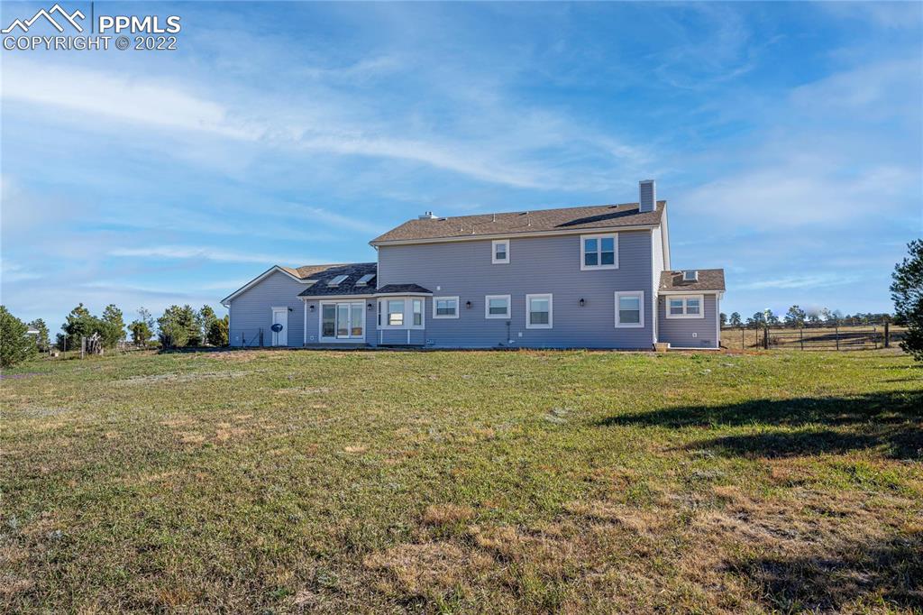 16250 Herring Road Colorado Springs, CO 80908 - Photo 43 of 50 a view of a house with a yard