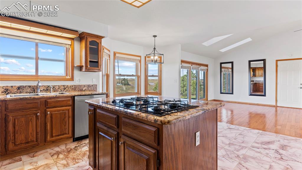 16250 Herring Road Colorado Springs, CO 80908 - Photo 6 of 50 a kitchen with stainless steel appliances granite countertop a stove a sink and a microwave